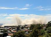 A plume rises following the Port Kembla Stack downing on Thursday. Pictures: KIRK GILMOUR