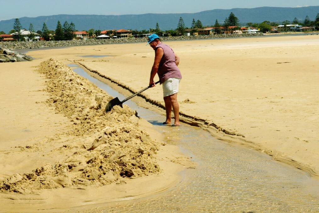 Mt Warrigal’s George Lane, fed up with the closure of Lake Illawarra’s entrance, is digging a channel to let the sea in.