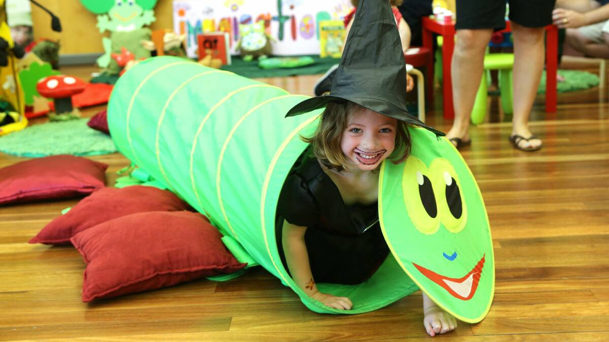Teagan, dressed as a witch, crawls through a caterpillar. Picture: KIRK GILMOUR