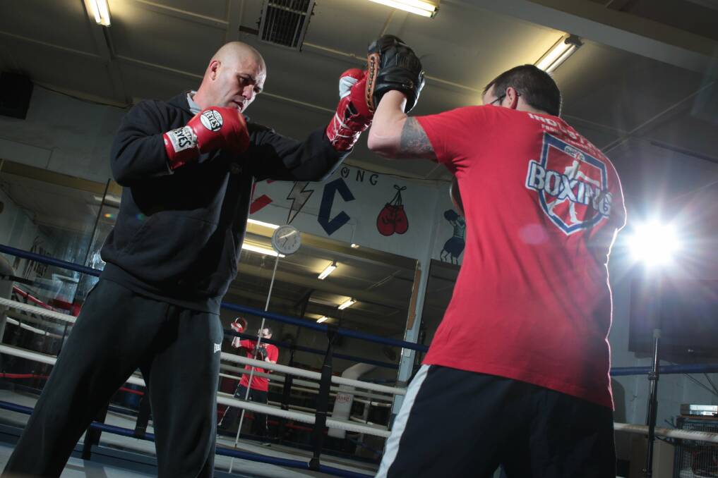 Shannon Taylor spars with Brad Gallagher in July for the first time since his drug overdose. Picture: KEN ROBERTSON