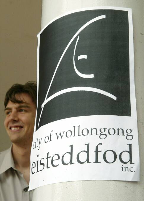 University of Wollongong graphic artist Sandy Houston with the City of Wollongong Eisteddford logo he created.