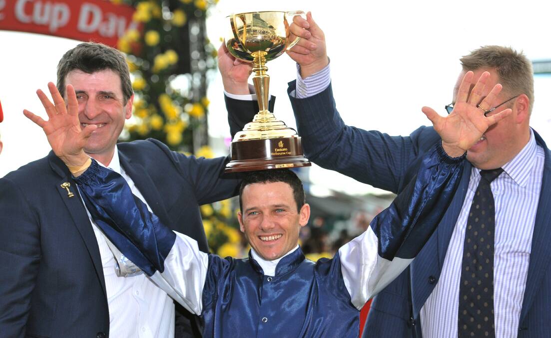 Trainer Robert Hickmott and Nick Williams with the cup over Brett Prebble's head. Picture: JOE ARMAO