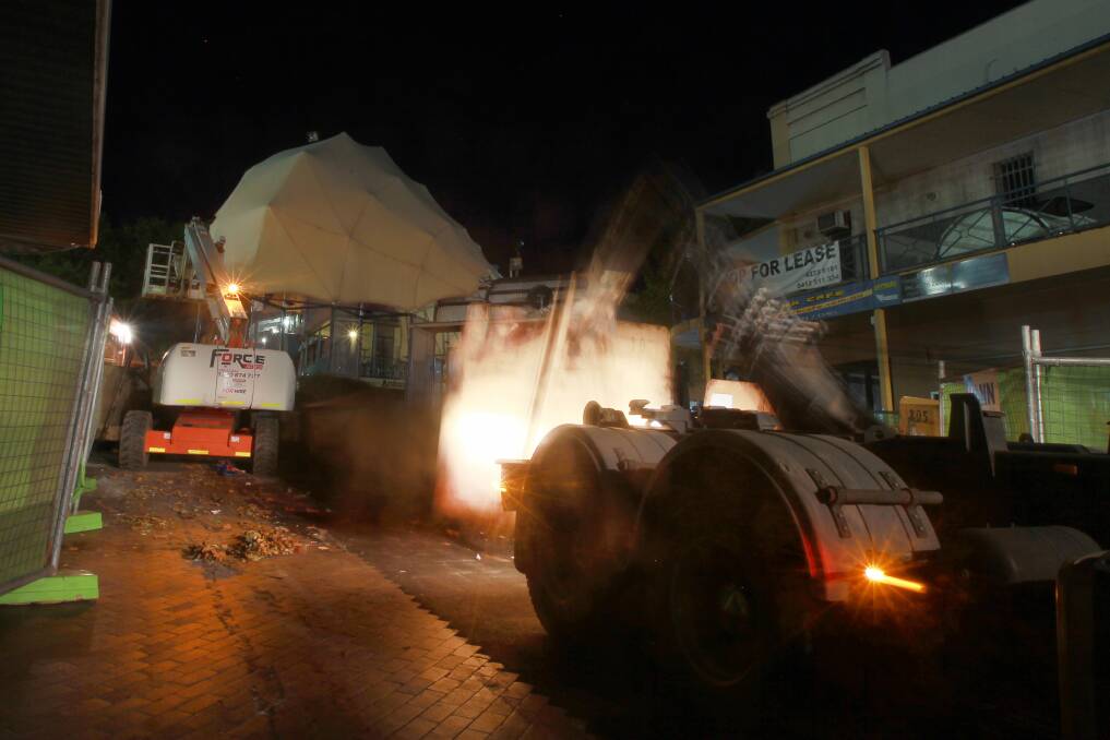 Work crews  undertake demolition work on the Crown Street Mall amphitheatre on Monday night. 