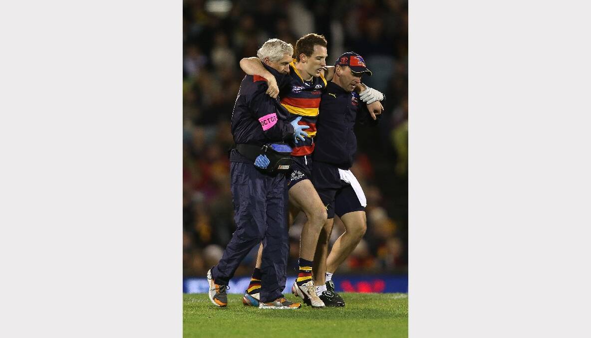 Aiden Riley is helped from the field in the Crows' clash against the Eagles at the weekend. Picture: GETTY IMAGES