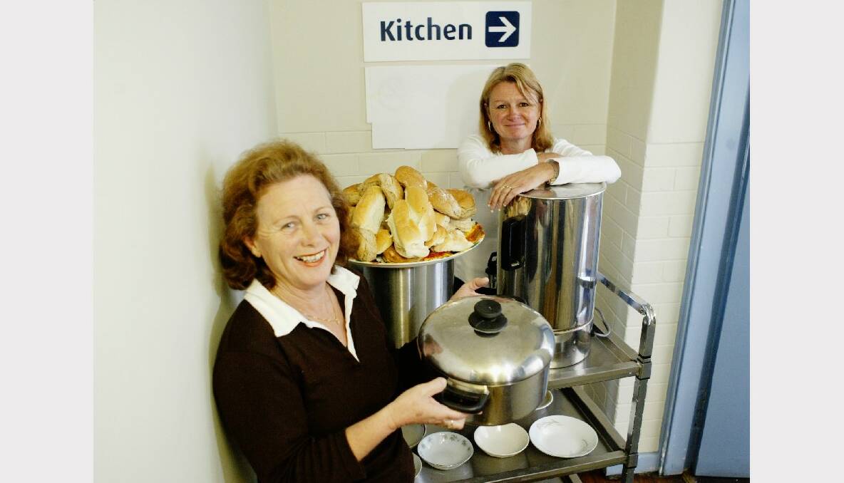 Delma Boland and Maxyne Graham open a soup kitchen with the help of volunteers at Warrawong Community Centre.