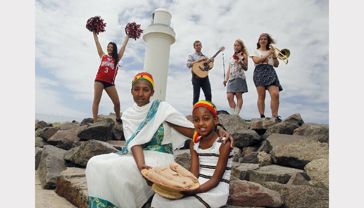 Kaila Minutillo (left), Selemawit Wosen and her daughter Mary Tebeje, 8, with Ethiopian food and musicians Tim Cantle, Andrea Cantle and Kiralee Cantle. Picture: ANDY ZAKELI