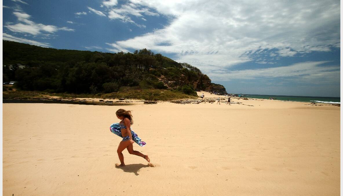 Sarah Byden of Bowral makes a run for it on blistering hot sand at Stanwell Park Beach. Pictures: KIRK GILMOUR, DAVE TEASE, ANDY ZAKELI