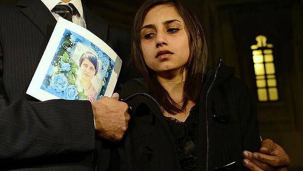 Lisha Barboza leaves Britain's Houses of Parliament carrying a photo of her late mother, Jacintha Saldanha. Photo: Reuters