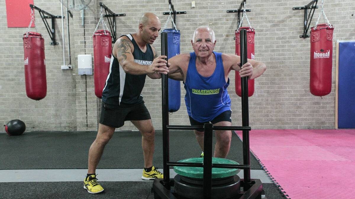 Personal trainer Max Lemme trains Stuart Kennedy, who has benefited greatly from exercise. Picture: CHRISTOPHER CHAN