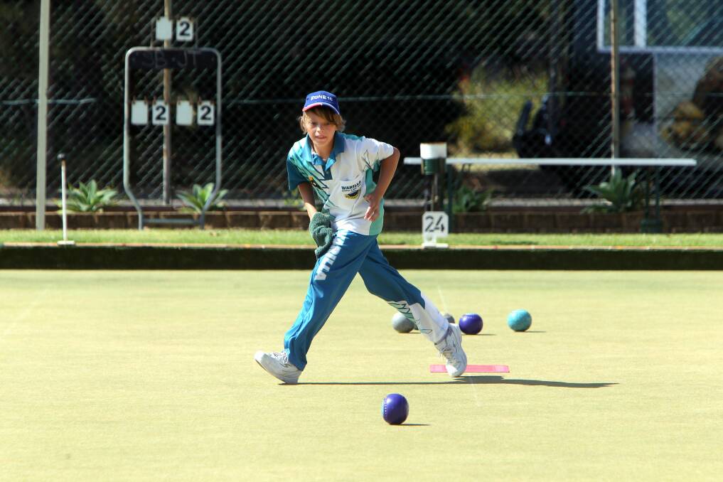 Warilla's Jayden Gebbe watches his bowl intently during the round of 16.
