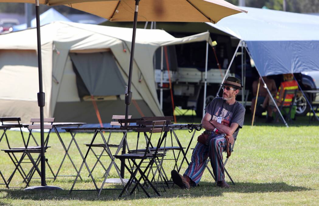 A festival-goer gets some shade at Bulli Showground. Picture: KIRK GILMOUR