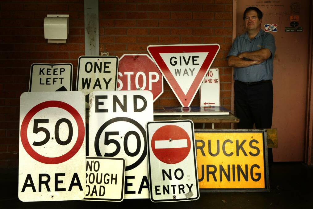 Terry Dean, Wollongong City Council works coordinator, with some of the signs recovered after what police described as the ''great sign heist''.