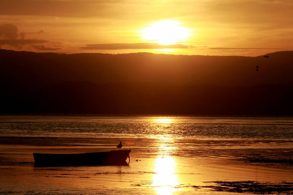A sunset over Lake Illawarra at Windang in April. Picture: ORLANDO CHIODO