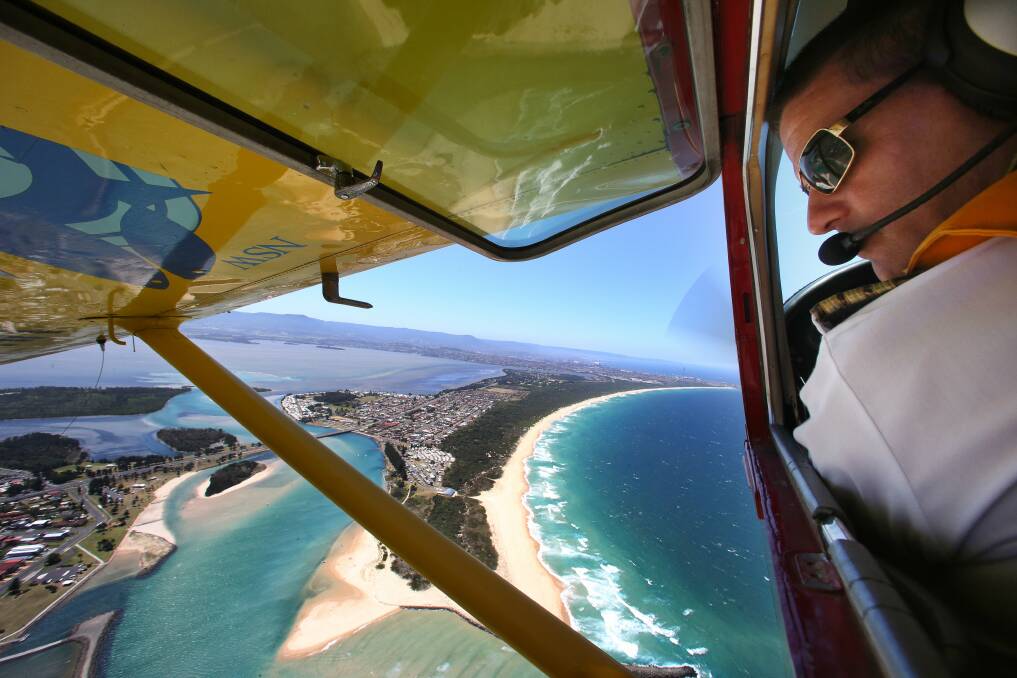 Pilot Chad Carey checks the Lake Illawarra entrance and off Windang Beach. Pictures: ADAM McLEAN 