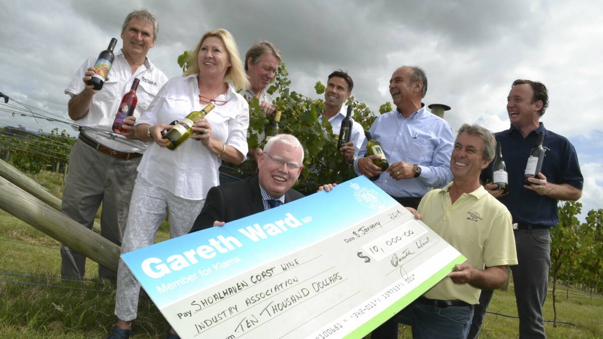 Gareth Ward presents a $10,000 cheque to Barry Starkey to support the 2014 Shoalhaven Winter Wine Festival. Picture: ROBERT CRAWFORD