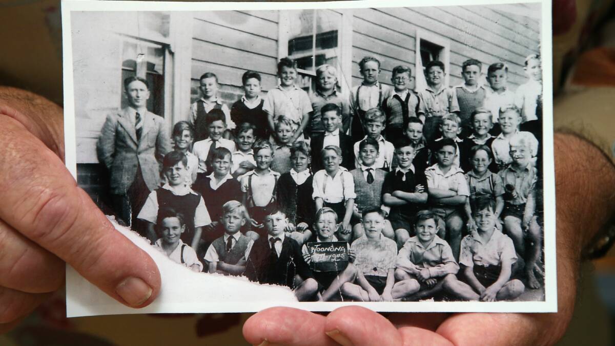 Graham Holmes holds a Woonona Public School photo from 1945. 