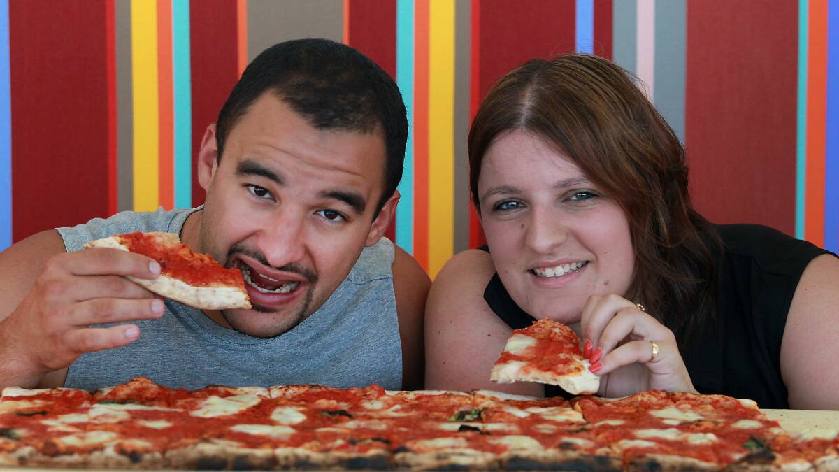 Reon Ponce and Bianca Stacic tuck into a metre-long pizza. Picture: ORLANDO CHIODO