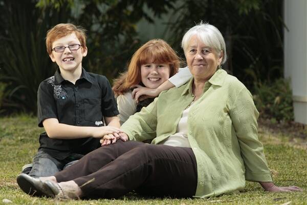 Vision-impaired siblings Hayden and Lily Pike with helper Dianne Arnold from Vision Australia. Photo: DAVE TEASE