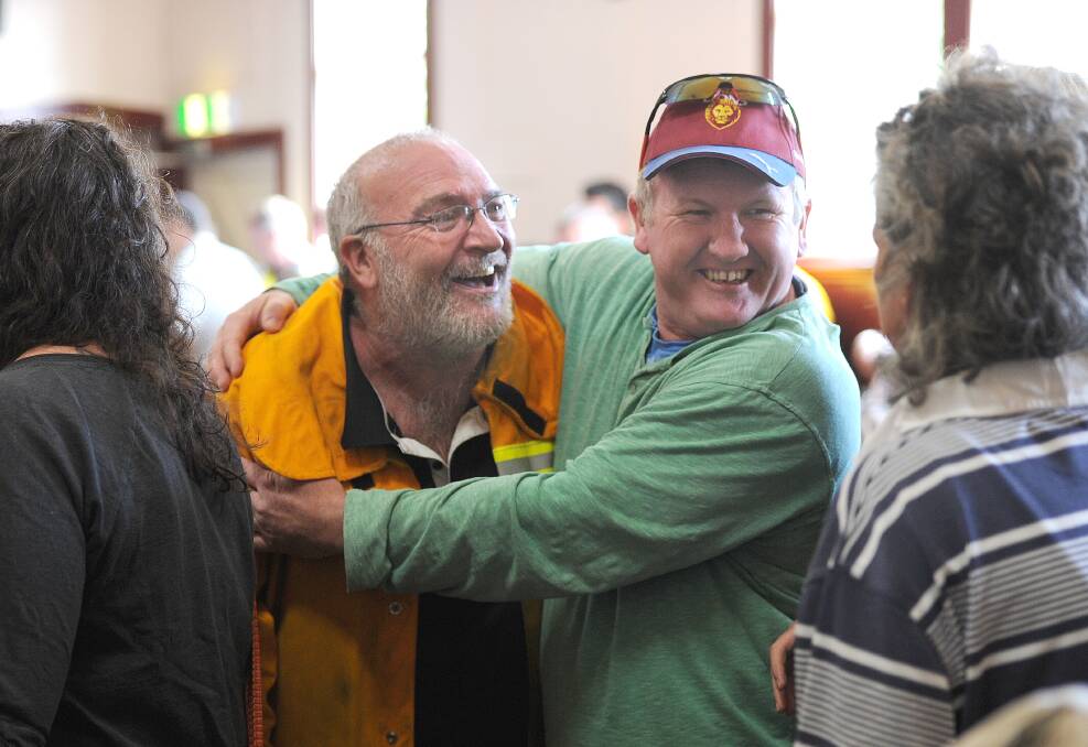 Community meeting at Snake Valley Community hall in the aftermarth of yesterdays fire in Carngham near Ballarat. Locals give firemen a hug. Photo: Wayne Taylor