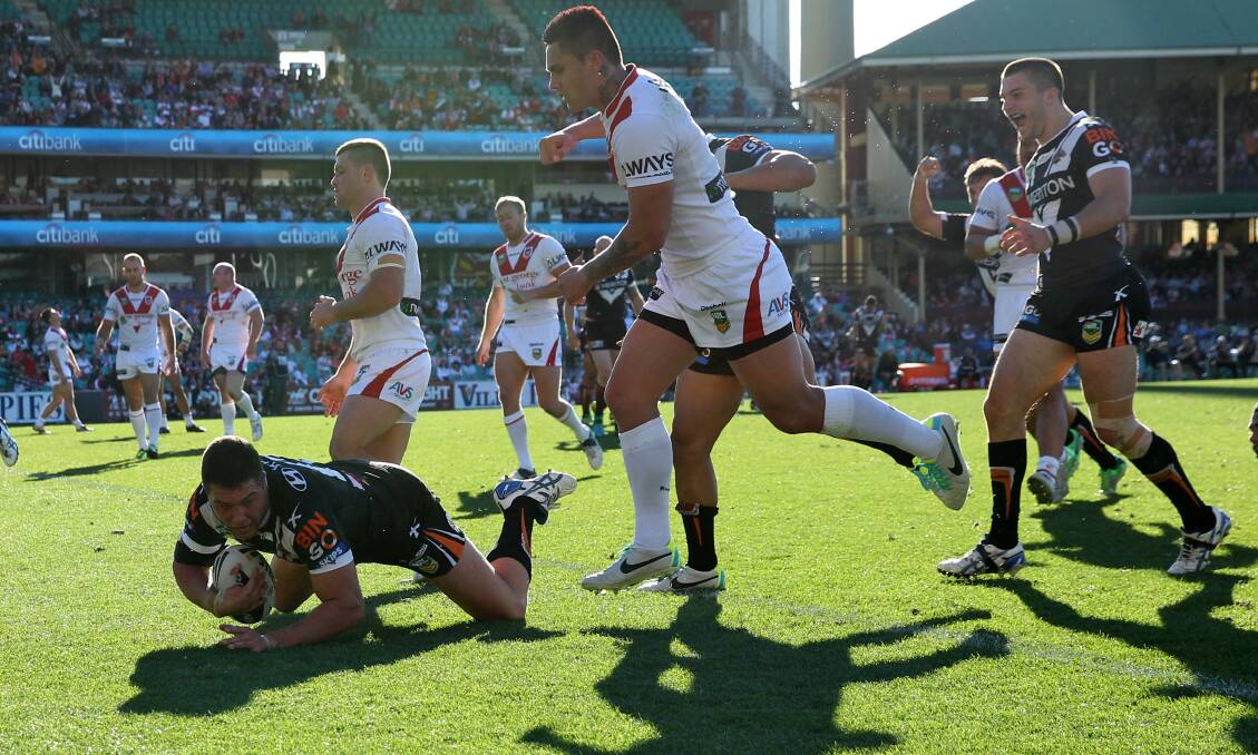 Curtis Sironen crashes over for the Wests Tigers against the Dragons at the SCG. Picture: BRENDAN ESPOSITO  