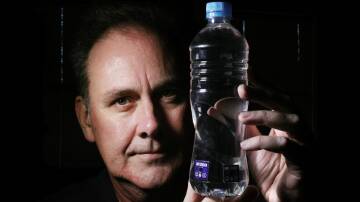 Dr Martin Butson holds a water bottle bearing the sticker that changes colour when the water is safe to drink. Picture by Sylvia Liber